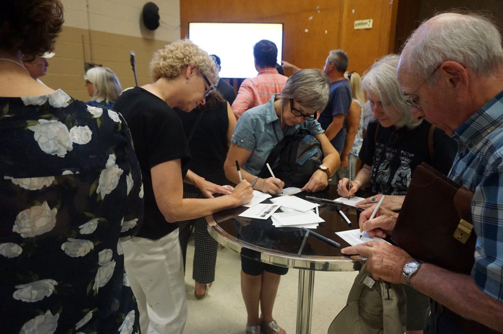 Community members filling out comment forms at the Second Community Meeting Held for Richview Square + 4620 Eglinton Ave. W.